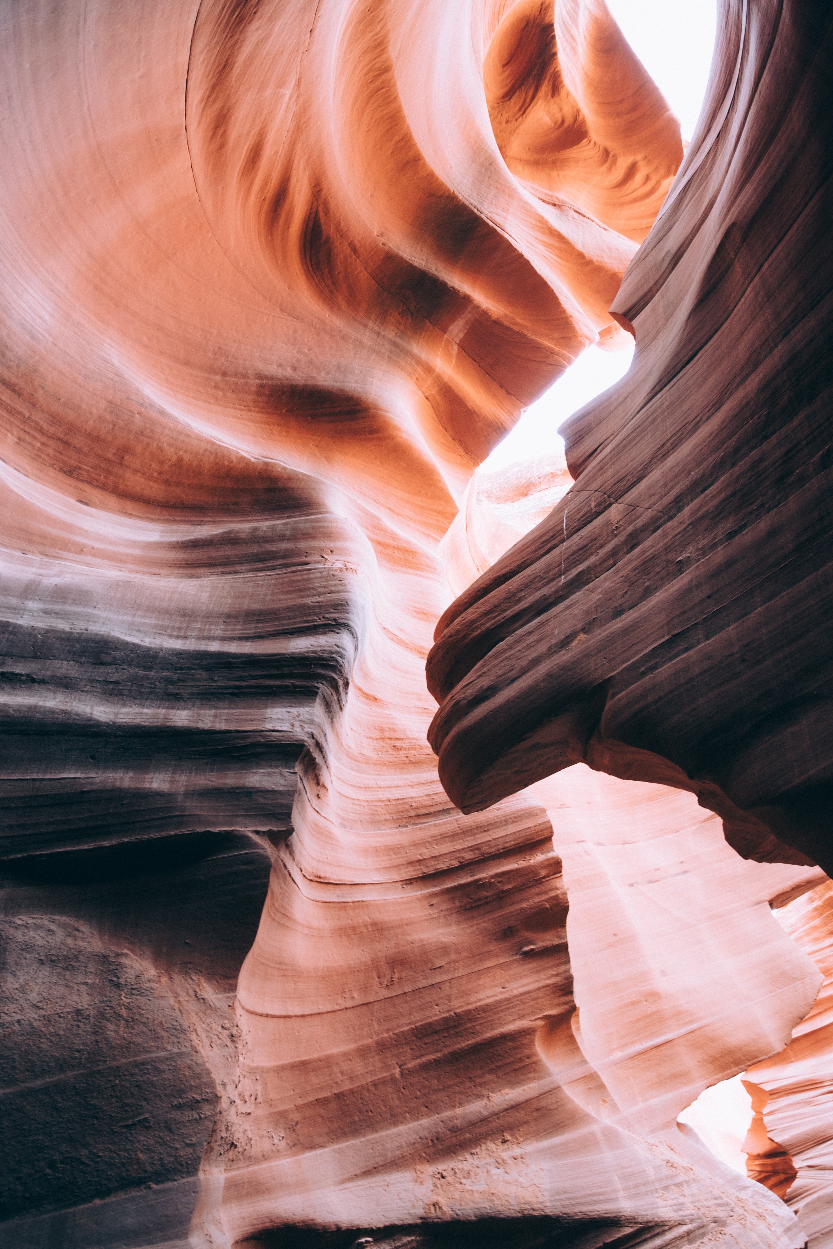 Narrow slot canyon with smooth, layered sandstone walls.